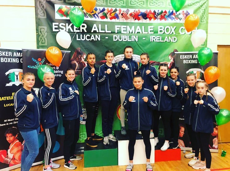 The East Midlands female squad posing for a photo on the Esker Box Cup podium.