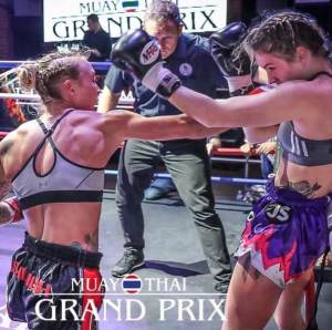 Ashleigh Johnson punching her opponent in a Muay Thai fight.