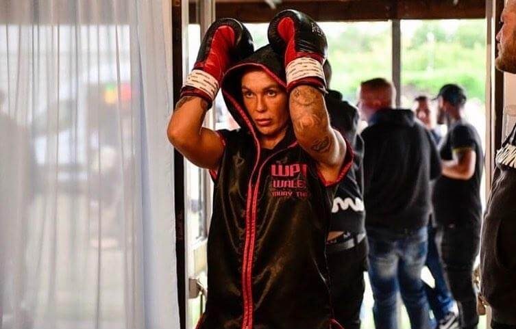 Ashleigh Johnson wearing a boxing robe and gloves.