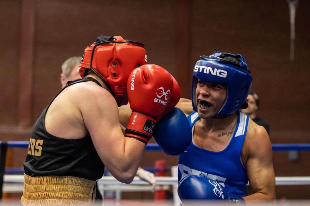 Omarah Taylor punching her opponent during an amateur boxing bout.