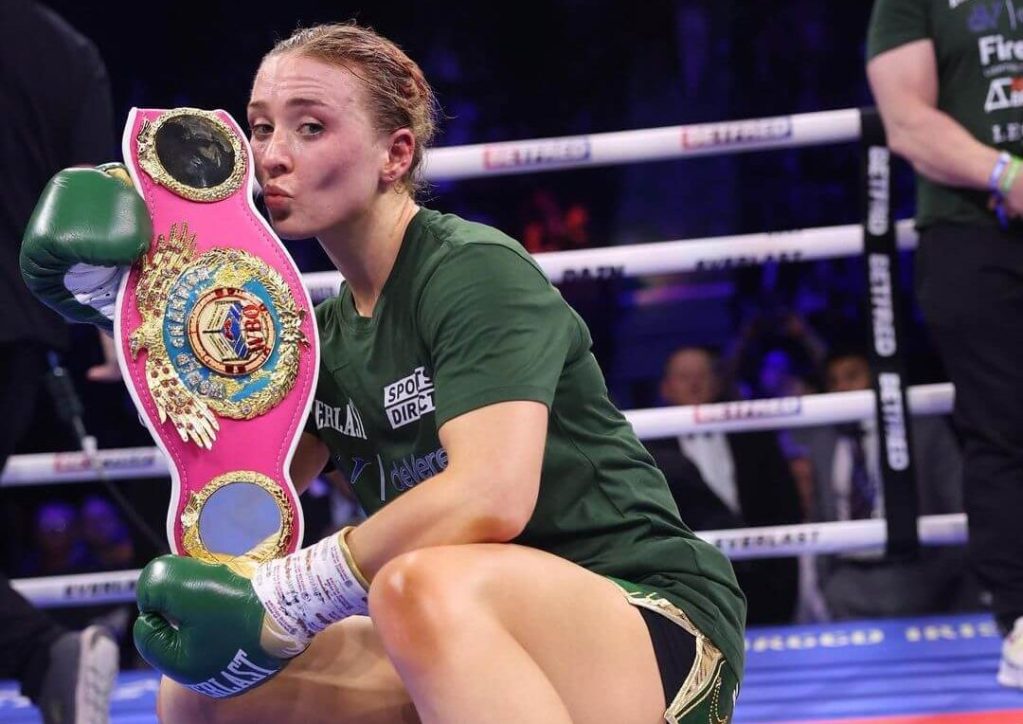 Rhiannon Dixon kissing the WBO World Lightweight belt.