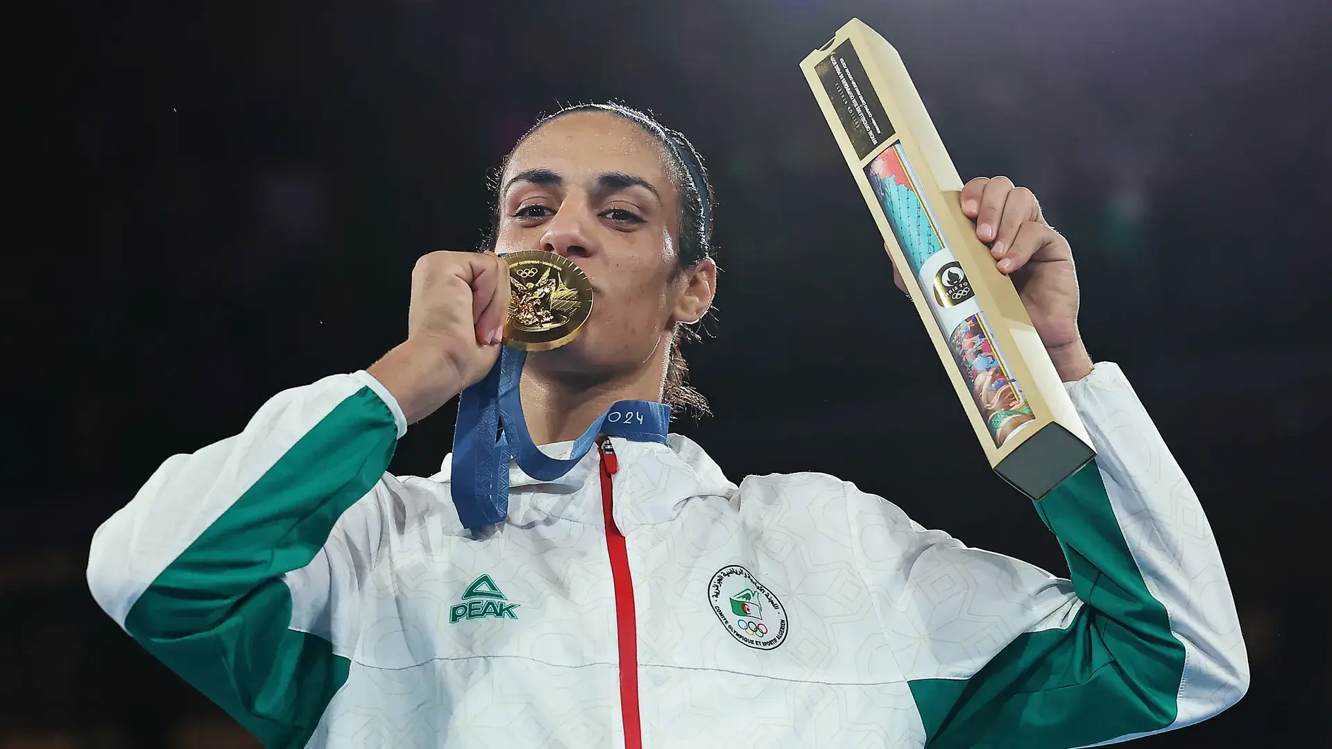 Imane Khelif kissing her Olympic gold medal.